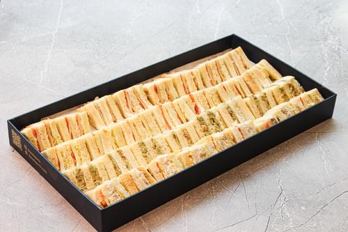 Mini club sandwich Box - 1. Chicken – Grilled chicken breast with fresh veggies and sauce. 2. Turkey – Sliced turkey with lettuce, tomato, and cheese. 3. Cheese – A mix of cheeses with crisp veggies 4. Falafel – Crispy falafel with tahina and salad
