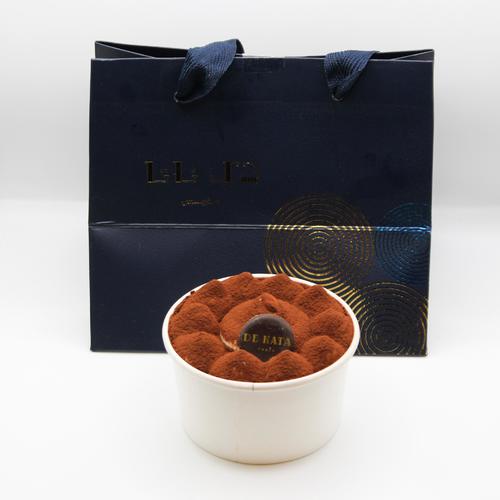 Tiramisu - cheer up with an elegant  ,rich layering of delicate ladyfingers , an  espresso -soaked low - denisty sponge cake surrounded by lightly sweetened whipped tiramisu cream with cacoa powder dusts on top of these of these layers for Additional texture and flavor .