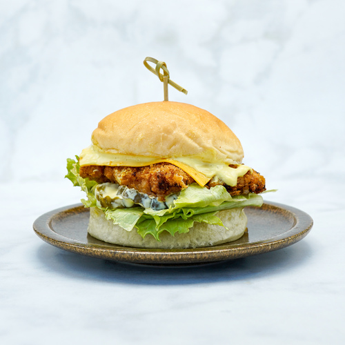 Pilot Burger - Breded Fried Chicken,Yellow Chedder Cheese,Pickle,Iceberg,Mustard Mayo Sauce Served In Freshly Made Potato Bun.