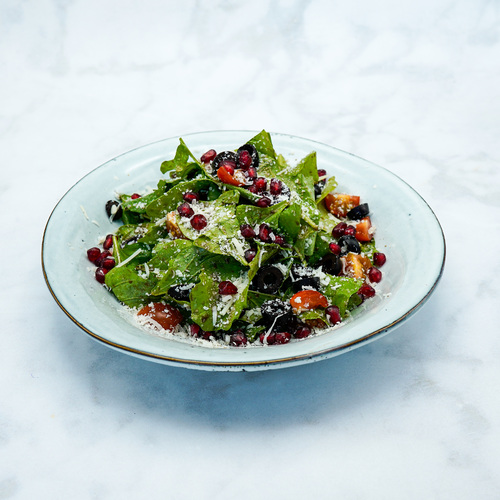 Rocca Salad - Rocca leaves , Sliced olives,pomegranate,Cherry tomato,Paramesan Cheese with Granaidin Syrup Dressing.