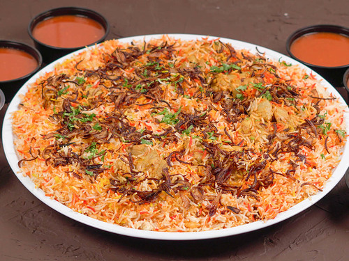 Chicken Biryani for 5 Persons - Chicken biryani tray, yogurt, green and red maboj, and broth.