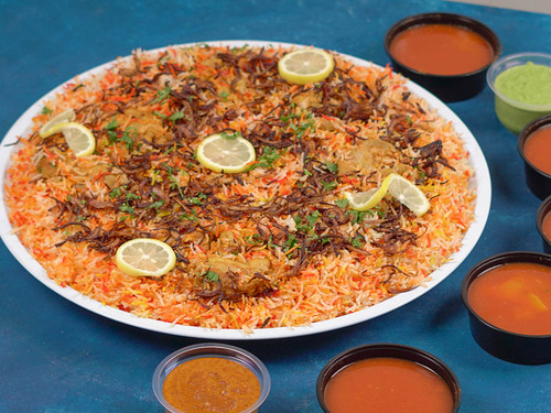 Chicken Biryani for 5 Persons - Chicken
Biryani tray, yogurt, achar, green and red maboj, and broth.