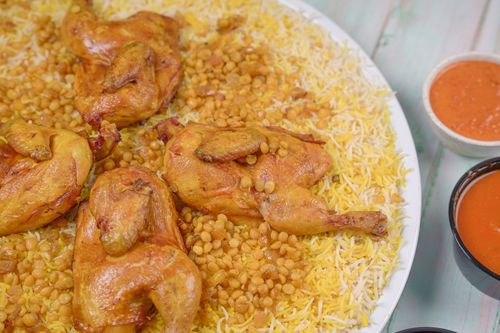 Umm Al 3ish - Chicken Machboos Platter for 4 Persons - 1 hares, 1 jaresh , 2 soup, 4 laban fresh, 4 maraq ,2 red maabouj 2
green maabouj , and 2 ajar.