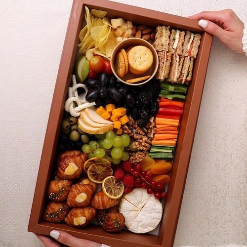 the platter - cheese plater&nbsp; contains mixed cheeses corrosion greeeps and crackers