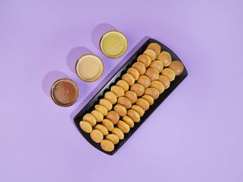 Mini Pancake Box - A 40 circular pieces of our signature pancake batter with 3 side dipping’s of your chosen sauces.