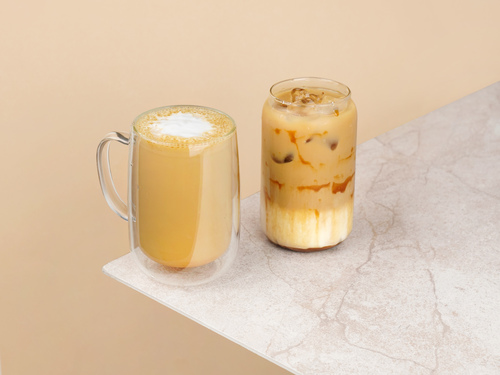 Iced Carmel Macchiato - Iced Caramel Macchiato a blend of freshly brewed espresso, creamy milk, and sweet caramel syrup, served over ice.