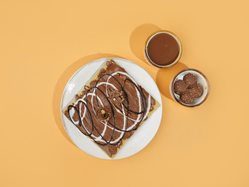 Ferrero Rocher Crepe - A thin type of pancake flavored with Ferrero chocolate garnished with Belgian milk, dark and white chocolate.