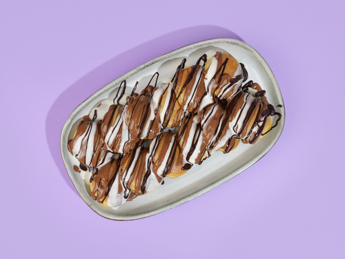 Mini Pancke Belgian - A 12 circular pieces of our signature pancake batter drizzled with Belgian milk, dark and white chocolate sauce.