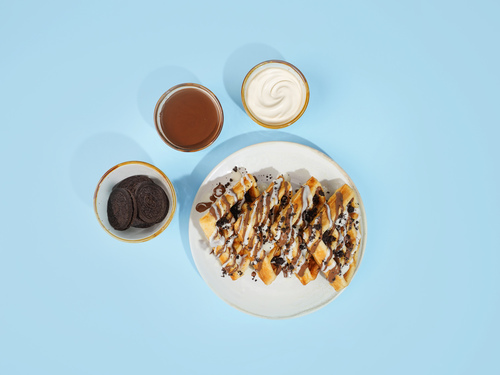 marble waffle - A 4 sliced waffle sauced with belgian milk and dark chocolate garnished with powdered oreo.