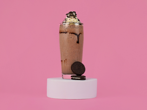 Oreo Milkshake - A combination of chocolate and vanilla ice cream blended with Oreo biscuit topped with whipped cream.