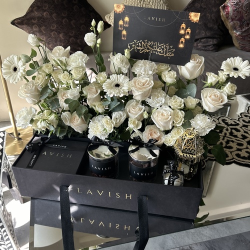 Lavish Flowers - Royal Neqsa - It Contains roses, carnations, baby roses with a golden crescent moon , lantern, 200 grams of Lavish chocolate, a special jar of pecans ,and special jar of pecans Swedish cocoa covered , natural soy candle and a greeting card.