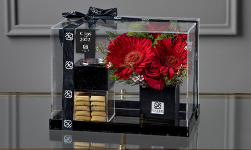 Graduation -4 - A box contains roses and gerbera arrangement with chocolate box and mubkhar. Width: 35 cm, Height: 23 cm