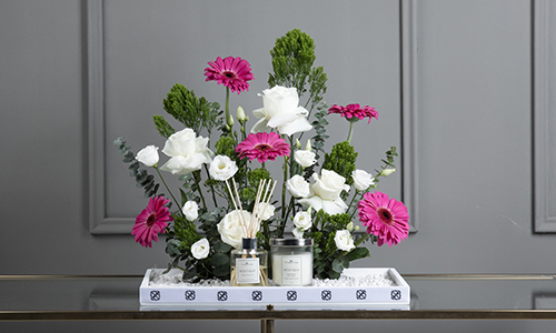 Adonis Bouquet - A tray that contains gerbera, big roses, lesanthus, trachelium and baby eucalyptus with diffuser and candle.
Height: 55 cm, Width: 48 cm