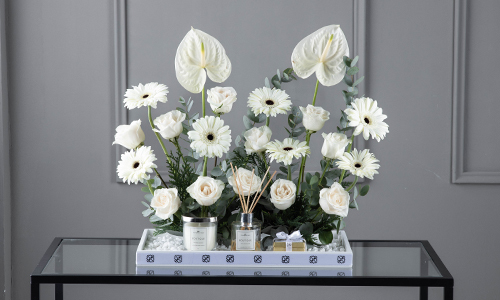 Zulian I - A tray contains gerbera, anthurium, big roses, eucalyptus and
  confern leaves  with Belgian chocolate,
  diffuser and candle..

    Height: 50 cm, Width: 48 cm