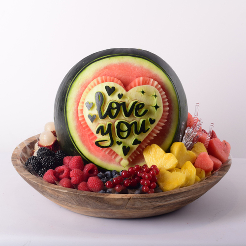 Habib Al Umor 33 - love
  you or costumized writing  on a  watermelon carving and fresh fruits on a
  wood tray.