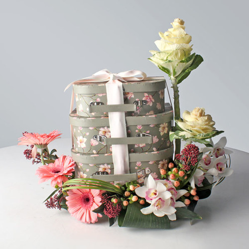 Mon Amoure 21 - 3 layer box of Arabic sweets (inside), decorated with brasica, skimmea, cymbidium, hypericum still grass, gerbera flowers and leaves around.