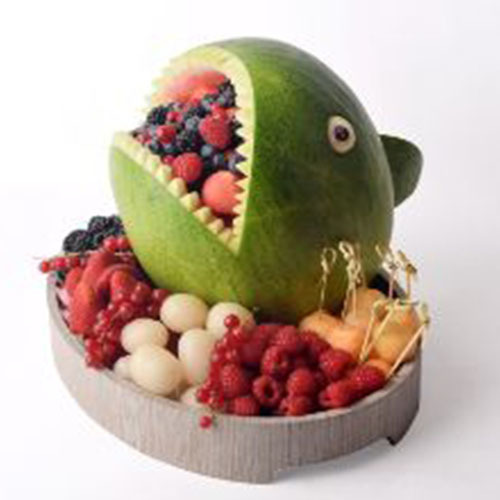 The Shark Fruit Tray - Watermelon carving Shark shape with fruits cut around , and inside it fresh berries salad.