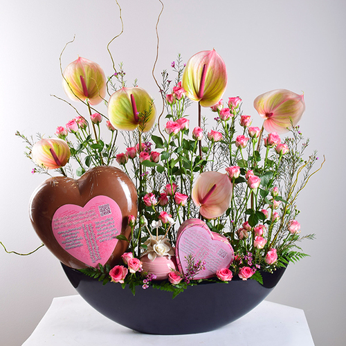 You & Me 35 - black
  acrylic tray decorated with big heart chocolate printed with barcode of a
  song, heart box with chocolates, perfume, and fresh anthiorium and roses
  flowers.