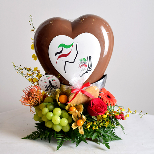 al khayal 5 - acrylic
  tray with a decoration of fresh gerbera, roses and pins flowers with assorted
  mixed fresh fruits and stand of national day big heart chocolate.