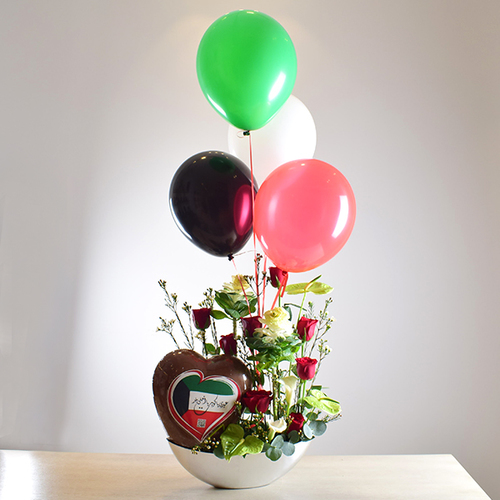 al khayal 8 - acrylic
  tray with a decoration of fresh , roses and brasica flowers with national day
  big heart chocolate and ballons.