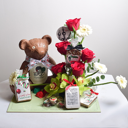 al khayal 13 - tray
  with a decoration of fresh roses, cymbidium and gerbera flowers with rice
  crispy , big teddy bear chocolate and chocolates.