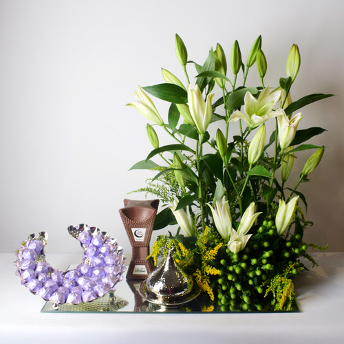 al eid hal helalah 10 - stainless
  silver moon tray with chocolates, 
  morroco tray with kuwaiti sweets inside, chocolate mubkhar and a
  decoration of fresh casa blanca flowers on a mirror tray.