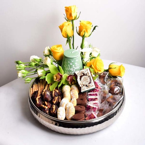 Ramadan Yijmana 46 - round
  tray decorated with ceramic tarbush, Quraan, dates with nuts, dried fruits,
  chocolates, kuwaiti sweets with roses and cymbidium flowers.