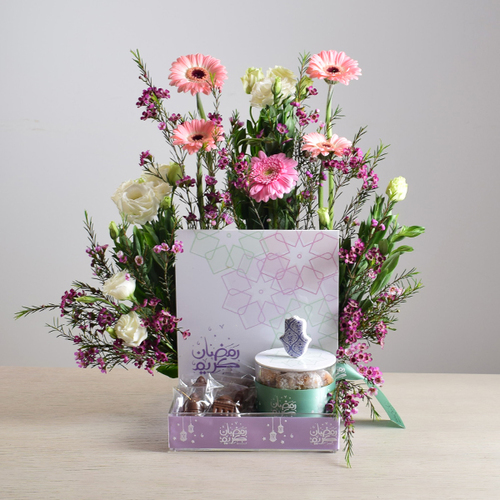 Ramadan Yijmana 52 - acrlic
  box of chocolates with acrylic jar of kuwaiti sweets decorated with fresh
  gerbera, roses and wax flowers.