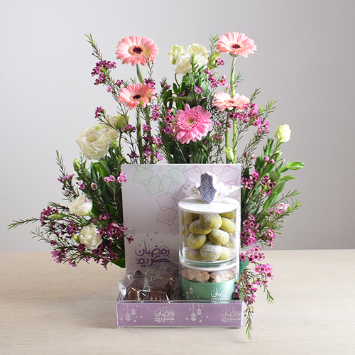 Ramadan Yijmana 54 - acrlic
  box of chocolates with 2 acrylic jar of kuwaiti sweets decorated with fresh
  gerbera, roses and wax flowers.