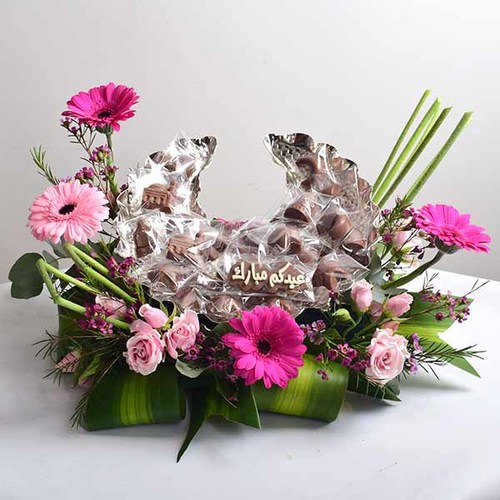 Al Eid - Crescent-shaped
  base decorated with natural gerbera, baby rose and wax flowers