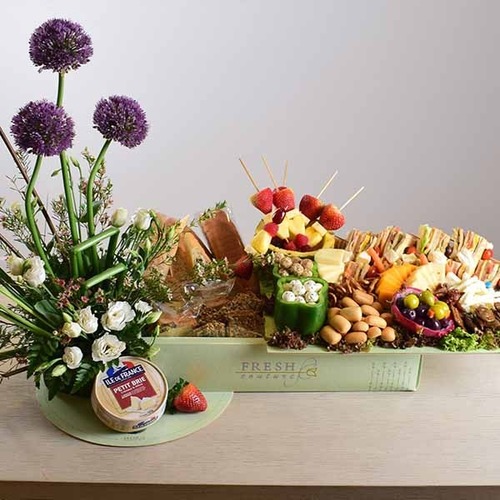 Al Eid 4 - tray contains cheese platters, bread,vegetables, fruits and sandwiches with a decoration of fresh anthorium, allum, lisiantus and wax flowers.