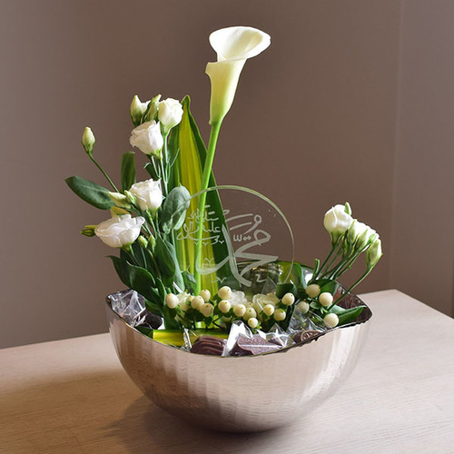 eid adhha & haj mabror 8 - silver
  tray with crystal Quran, chocolates and a decoration of fresh calla,
  lisianthus and hyphericum flowers.