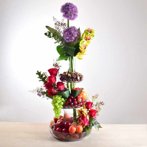 al khayal 16 - 3
  layer glass vase with dates with nuts, mixed fresh fruits, and a decoration
  of fresh roses, allum,cymbidium and wax flowers.