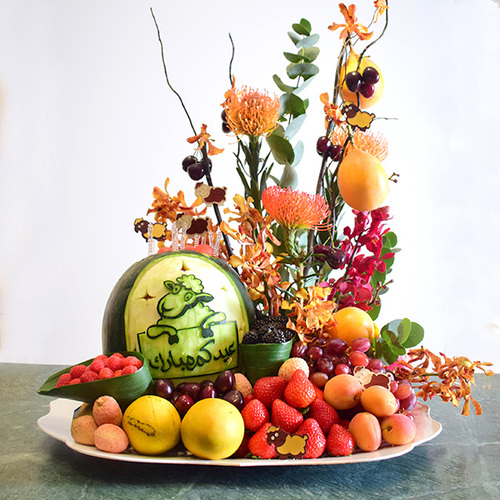 eid adhha & haj mabror 26 - eid
  al adha fresh fruits tray with watermelon carving and a decoration of fresh
  baby orchid, salix and pins flowers.