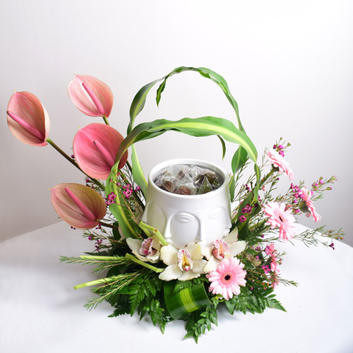 vase face 2 - face
  design ceramic vase with chocolates and a decoration of fresh anthorium,
  gerbera and cymbidium flowers