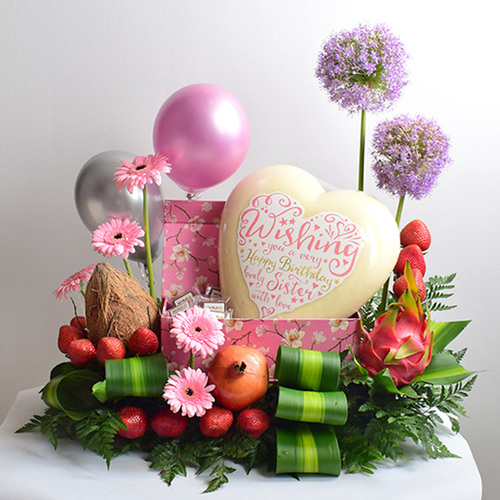 Birthday 4 - Happy
  Birthday Writing on a Big Heart White Chocolate with fresh gerbera, allum and
  salix flowers on a box with Ballons, fresh fruits and chocolates.