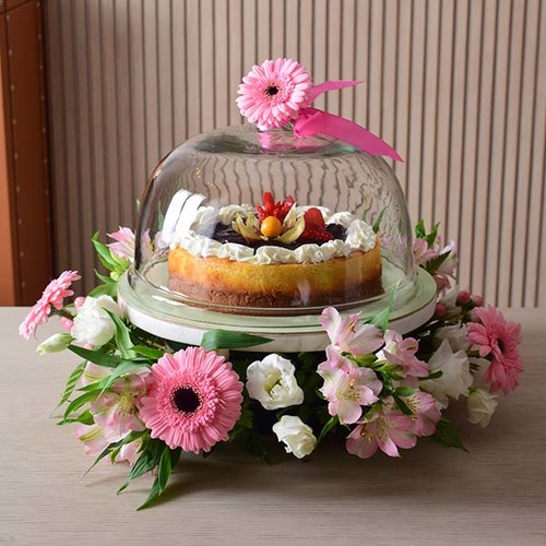 someone special 3 - cheesecake
  on a glass and marble stand pan with a decoration of fresh gerbera, astomeria
  and lisianthus flower