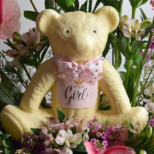 Baby Girl 2 - White
  chocolate teddy bear with the decoration of fresh gerbera , anthorium, wax
  flower and astomeria flowers on a tray.