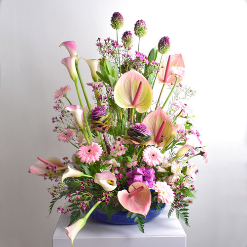 Gift 3 - 2 Can
  tray with  chocolates and a decoration
  of fresh anthorium, gerbera, calla and wax flowers.