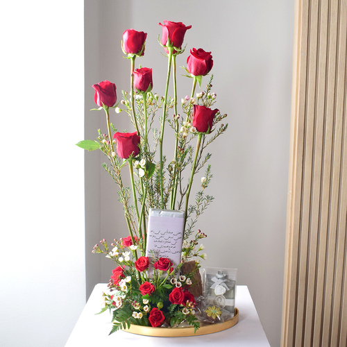 Anta Auomri 13 - round
  golden tray with home perfume, chocolates, Chocolate bar, chocolates, cookies
  and brownies with a decoration of fresh roses and wax flowers.