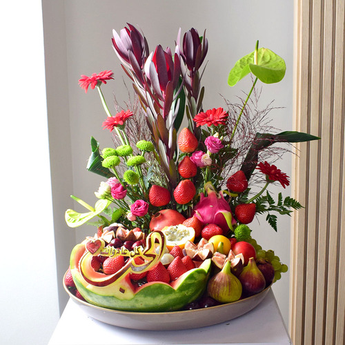 Fresh Couture - Anta Auomri 30 - Watermelon
  carving with fresh mixed fruits with a decoration of fresh antorium, gerbera,
  lisianthus, safari and crysanth flowers on a can tray.