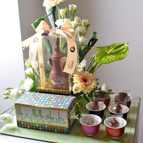 Me & You 9 - Dalah
  Chocolate with box of kuwaiti sweets, chocolates on a 6 pcs ceramic tea cups
  set and a decoration of fresh gerbera, anthorium and lisianthus flowers on a
  board tray.