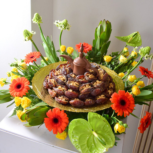 Me & You 15 - 1 kilo
  of dates with nuts with 1 Dallah design chocolates on a gold color tray with
  a decoration of fresh gerbera, anthorium ,Ranantuhalium, safari and Baby
  Roses flowers.