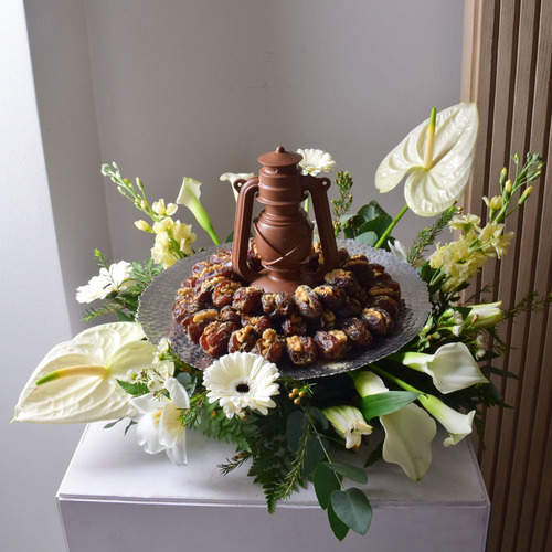 Me & You 16 - fanoosh
  chocolate with dates with nuts on a tray with a decoration of fresh
  anthorium, gerbera, calla, matola and wax flowers.