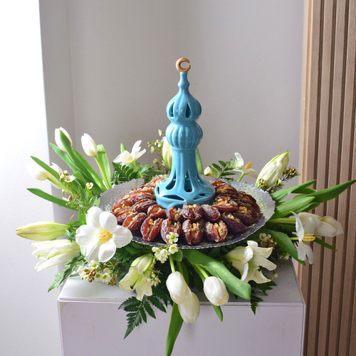 Me & You 23 - ceramic
  mosque with dates wih nuts on a tray with a decoration of fresh casa blanca ,
  tulips and wax flowers.