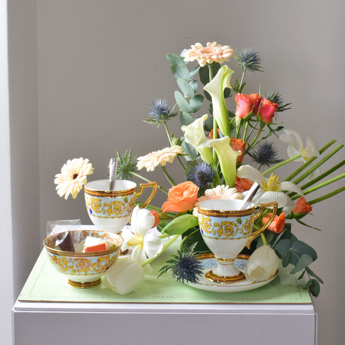 Me & You 25 - ceramic
  cups set with a decoration of fresh roses, gerbera and eryngium flowers with
  chocolates