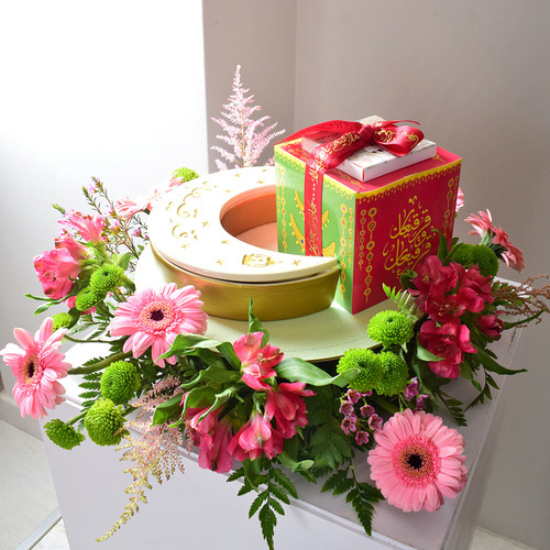 Me & You 32 - round
  tray with ceramic moon box with 1 box of 
  kuwaiti sweets with a decoration of fresh gerbera, astromeria,
  chrysanth, astilbe and wax flowers.