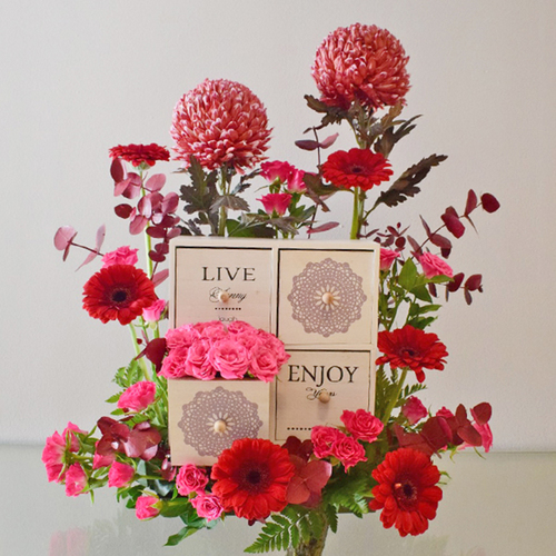 Live, Enjoy, Love 1 - Wood
  Box with chocolates and fresh Gerbera, baby roses and Deco Peonia.