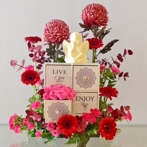 Live, Enjoy, Love 2 - Wood
  Box with chocolates (Angel Chocolate) and fresh Gerbera, baby roses and Deco
  Peonia.