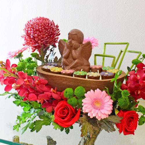 Angel Love - wood
  tray with scented candle, chocolates and fresh roses, baby orchid, gerbera,
  crysanthinum and deco peonia flowers.